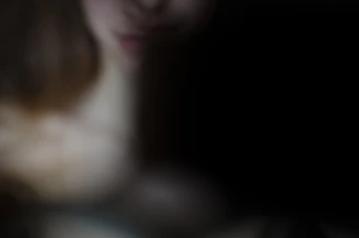 A shadowy figure fading into a deep black background with red glitch lines.