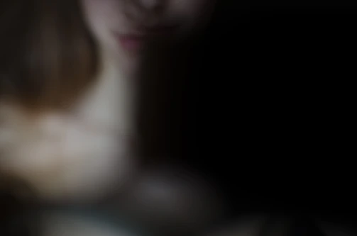 A shadowy figure fading into a deep black background with red glitch lines.