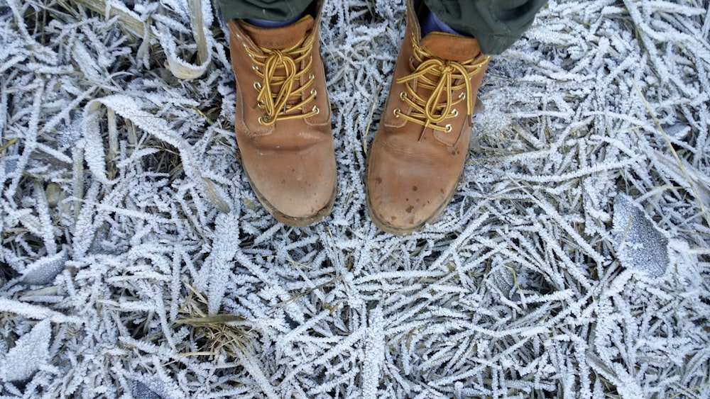 person wearing brown leather work boots