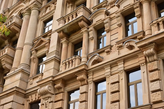 low angle photo of brown painted high rise building in Frankfurt Germany