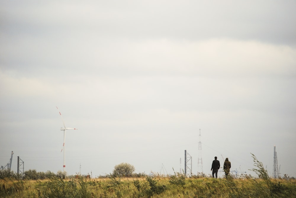 photography of two people walking on road