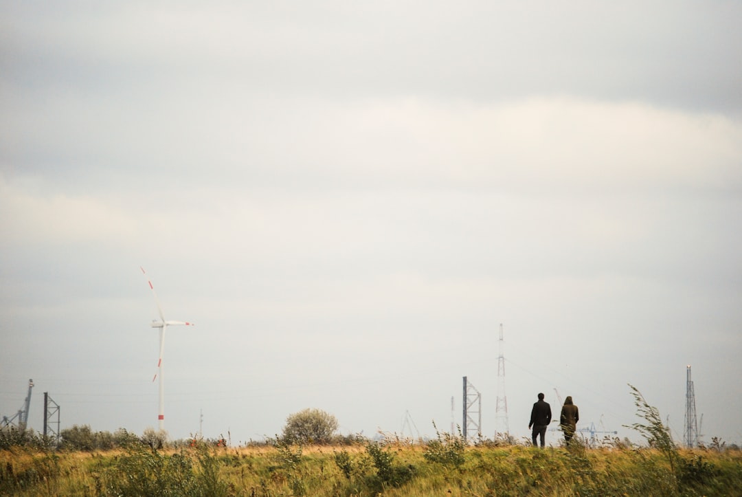 photography of two people walking on road