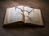 framed eyeglasses on top open book