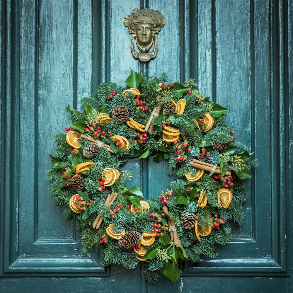 photo of green door wreath mounted in green wooden door