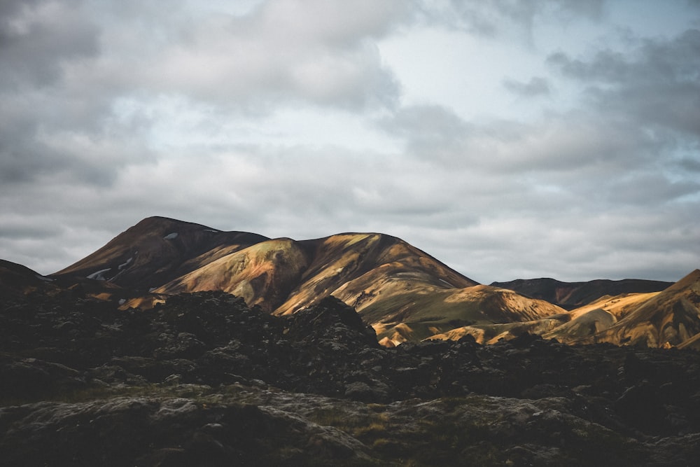 mountain under cloudy sky during daytime