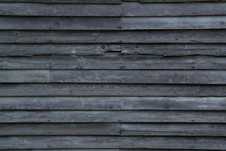 An inviting accent wall made of reclaimed wood panels with varied textures and warm tones.