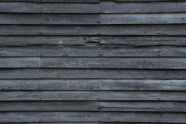 An inviting accent wall made of reclaimed wood panels with varied textures and warm tones.