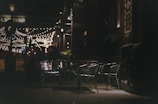 Evening view of the restaurant’s outdoor seating with twinkling string lights.