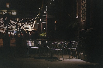 Evening view of the restaurant’s outdoor seating with twinkling string lights.