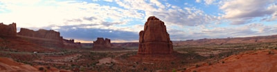 A panoramic view of the Arizona Peace Forum annual gathering with participants exchanging ideas under a bright sky.