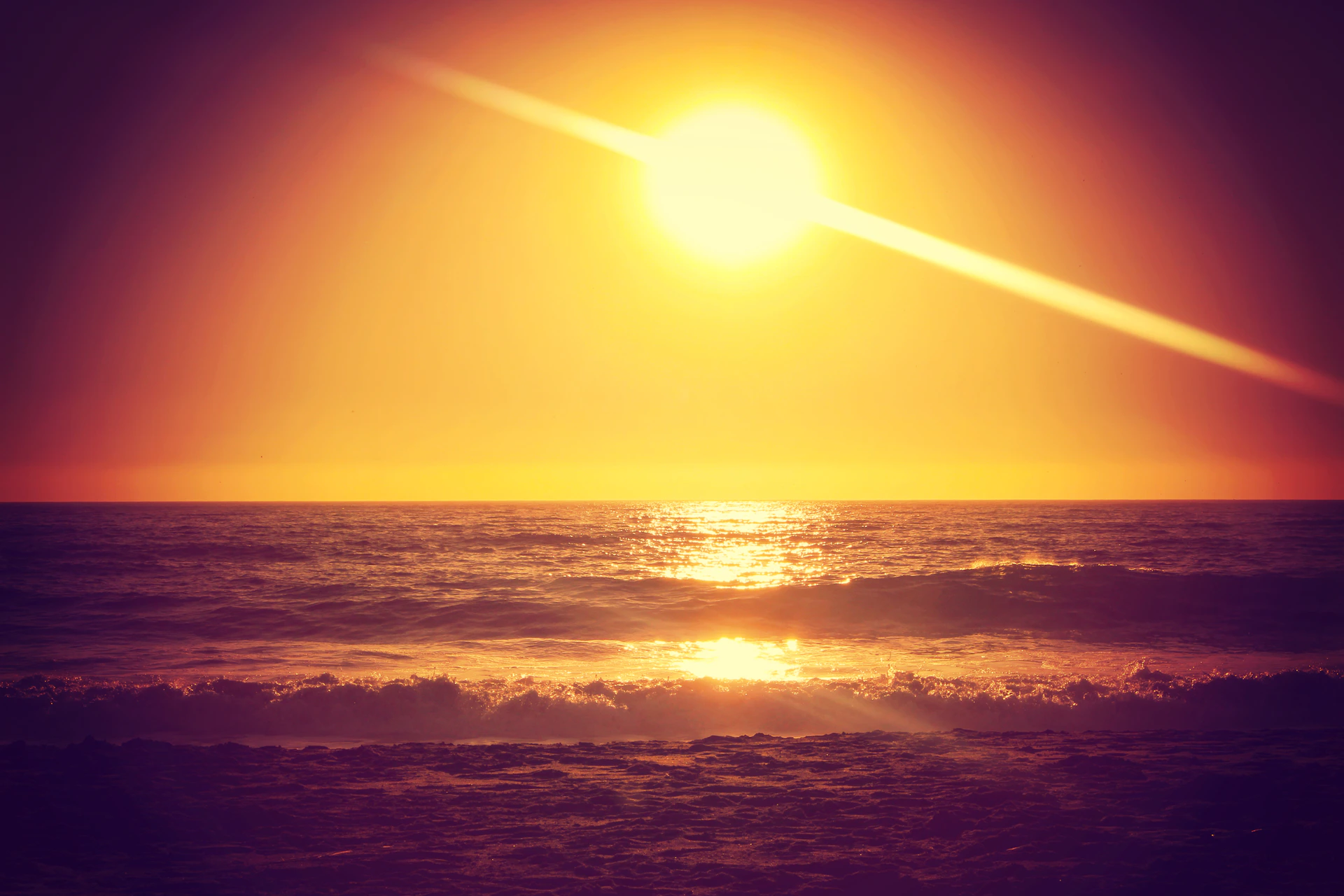 Sunset over the ocean horizon as seen from the beachfront properties at Vistamar Residences, with warm golden light reflecting on the water.