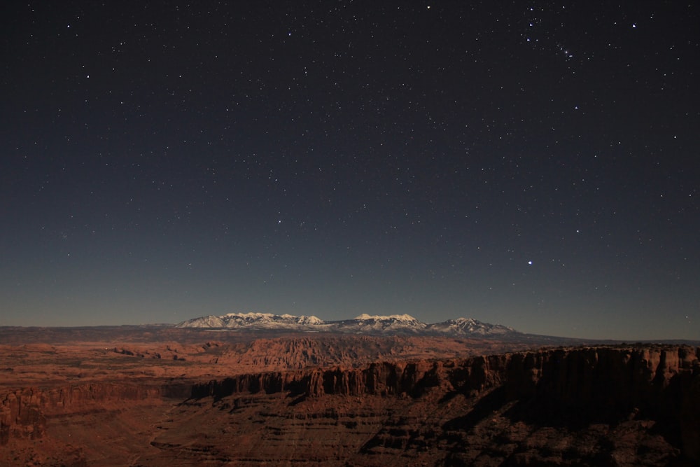 brown mountains under blue sky during night time