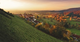 A picturesque village nestled in the hills during autumn.