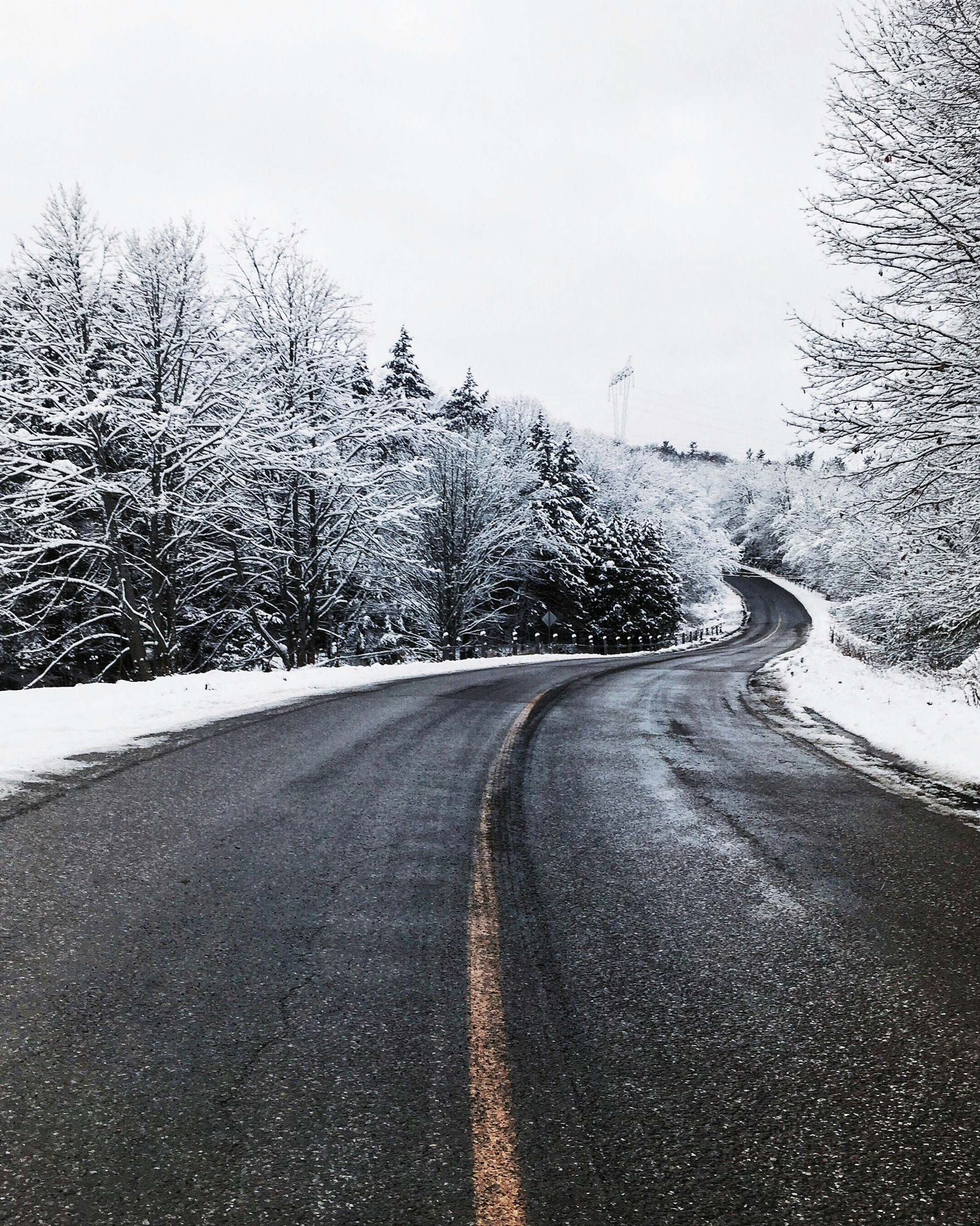 asphalt road in the middle of snow