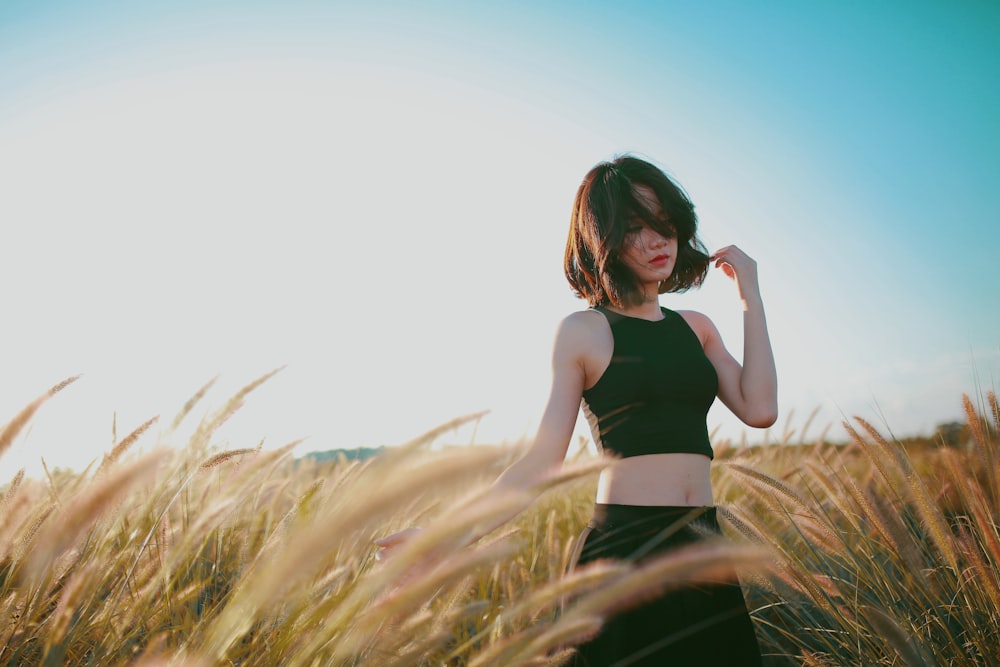 woman on wheat field during daytime