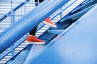 person stepping on blue stairs
