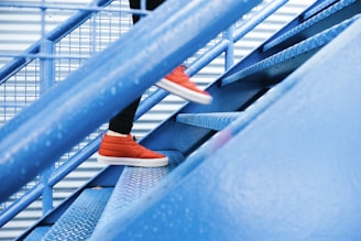 person stepping on blue stairs