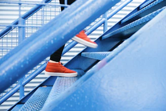 person stepping on blue stairs