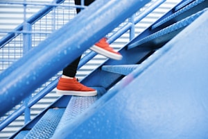 person stepping on blue stairs
