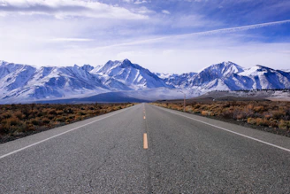 The open road stretching ahead with the mountains looming, hinting at the adventures yet to come.