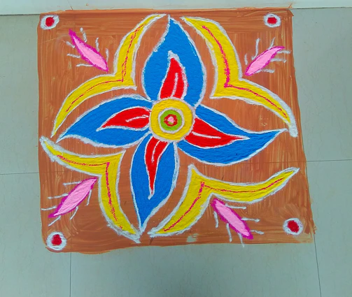 A vibrant rangoli design in bright colors, crafted with intricate floral patterns on a traditional Indian floor.