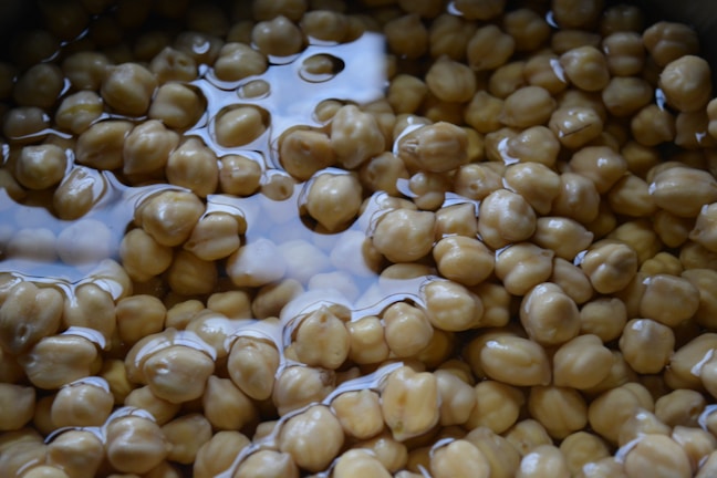 Workers inspecting chickpeas during quality check in a clean facility.