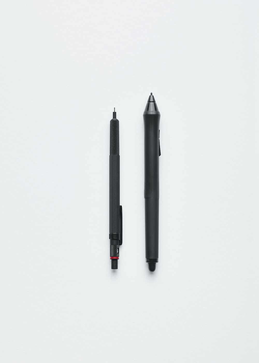 A mechanical pencil and a pen.
