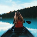 blonde haired woman riding on boat