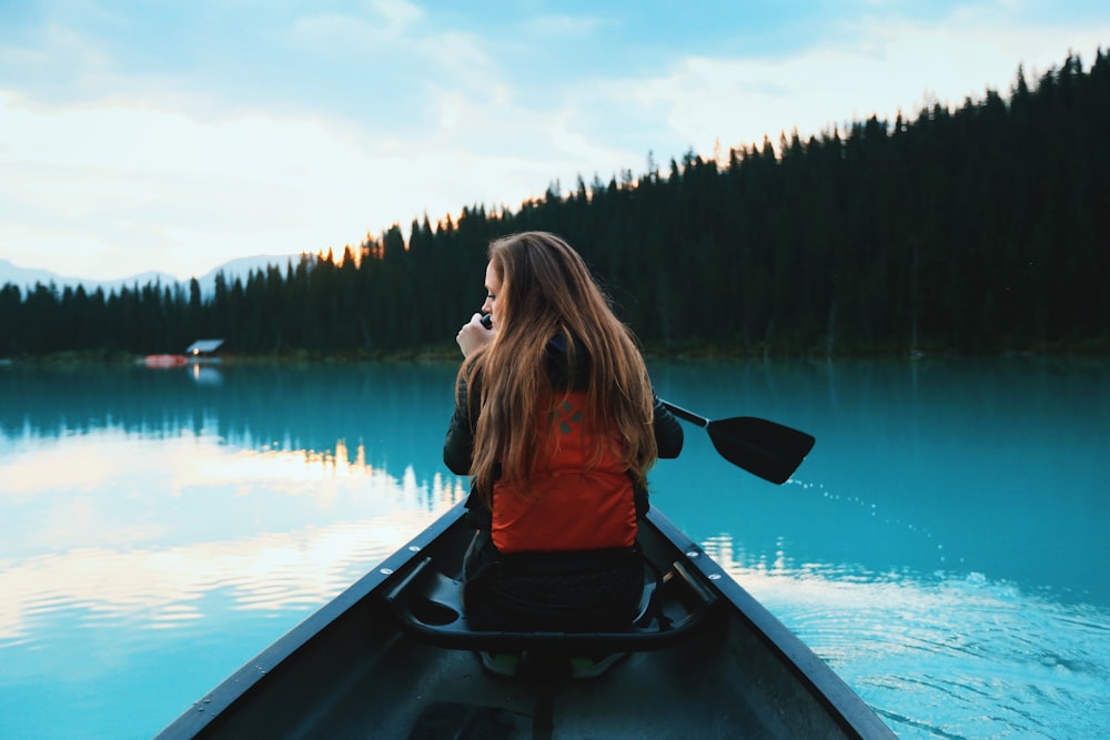 blonde haired woman riding on boat