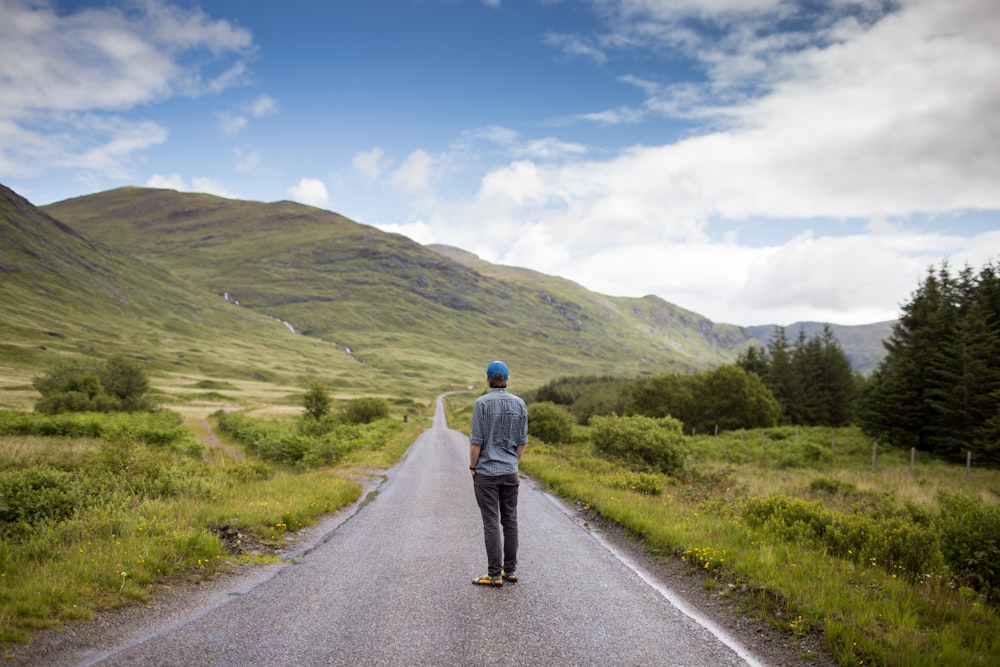 man standing on concrete road