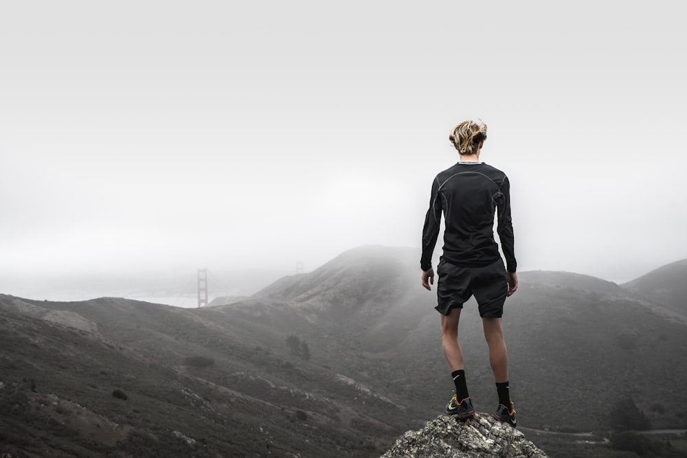 man standing on top of mountain