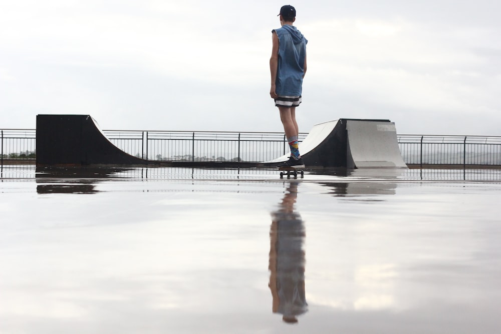 man standing on skateboard near ramp