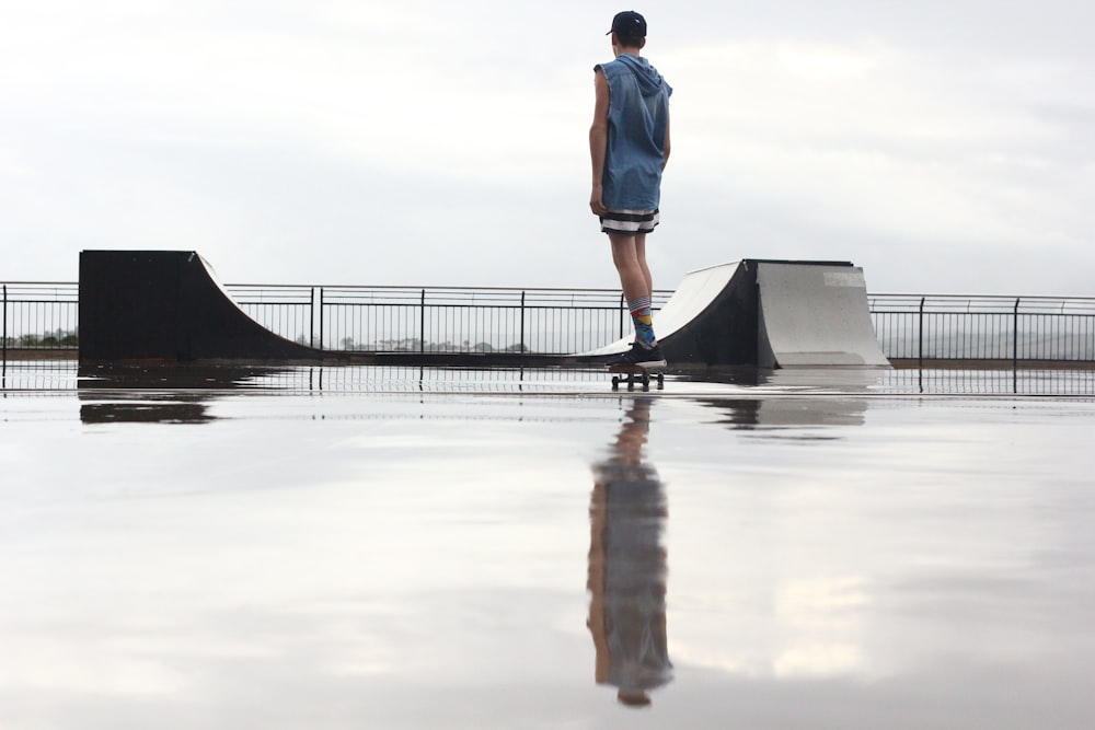 uomo in piedi sullo skateboard vicino alla rampa