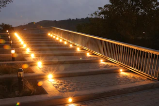 Close-up of a beautifully crafted stone patio with warm lighting at dusk.