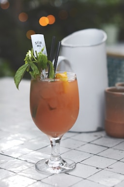wine glass with juice in shallow focus photography