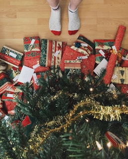 person standing beside christmas tree