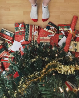 person standing beside christmas tree