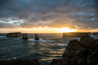 A stunning sunset over the limestone cliffs and clear waters of Krabi's coastline.