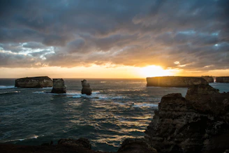 A stunning sunset over the limestone cliffs and clear waters of Krabi's coastline.