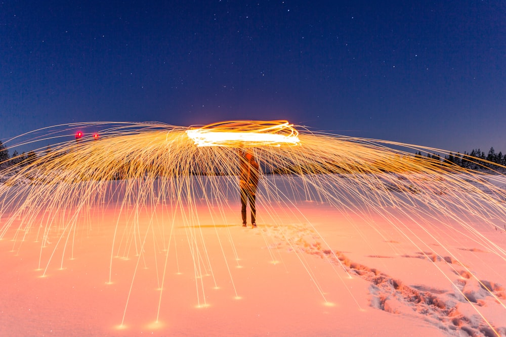 time lapse photography of man performing fire dance