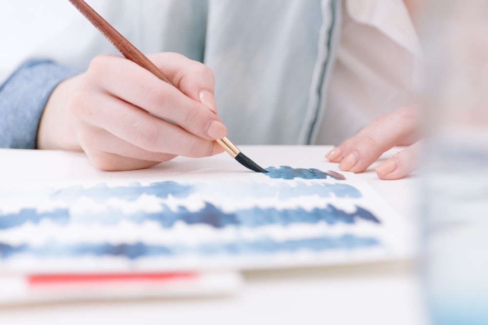 person holding paint brush