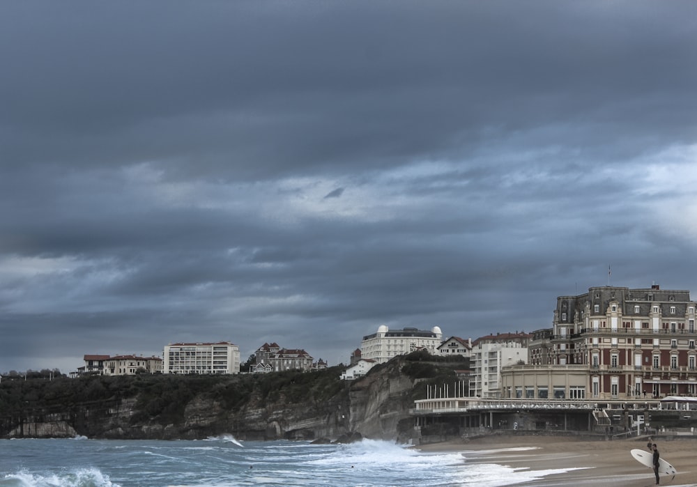 concrete buildings by the sea during daytime