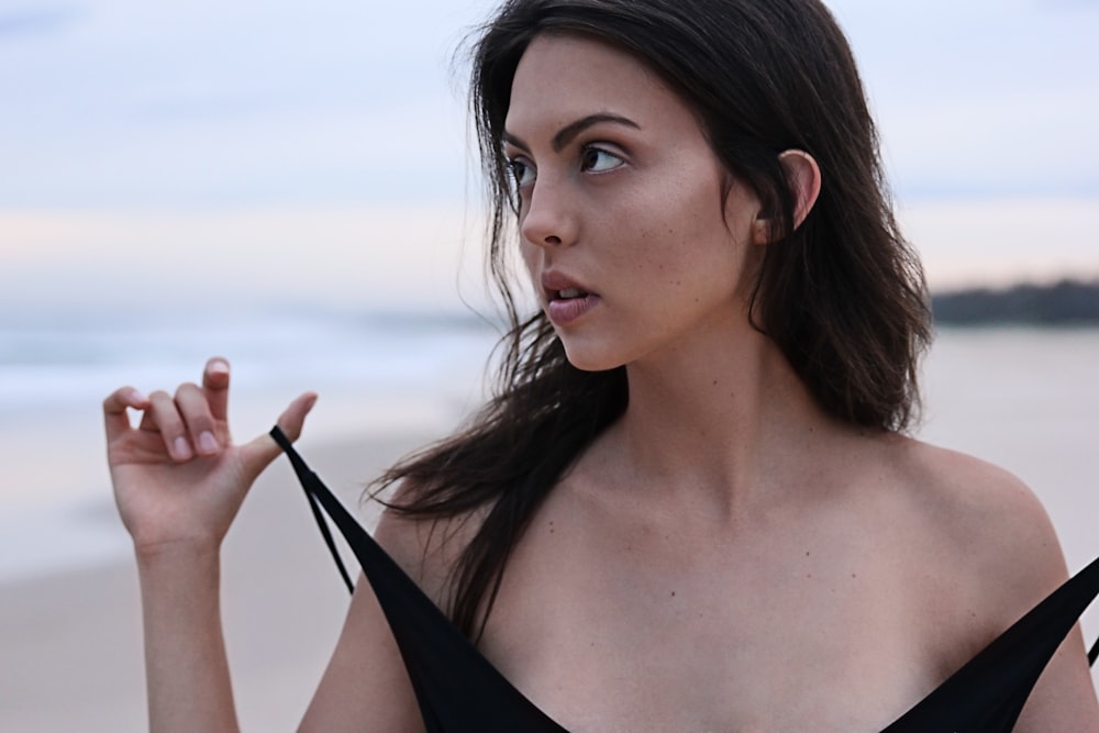 woman about to take off her clothes at the beach