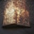 An open book appears to be engulfed in swirling flames, with sparks and smoke surrounding it. The intense fiery effect creates a dramatic and surreal scene, suggesting destruction or transformation.