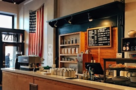 flag of U.S. America hanging on white painted concrete wall