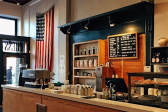 flag of U.S. America hanging on white painted concrete wall