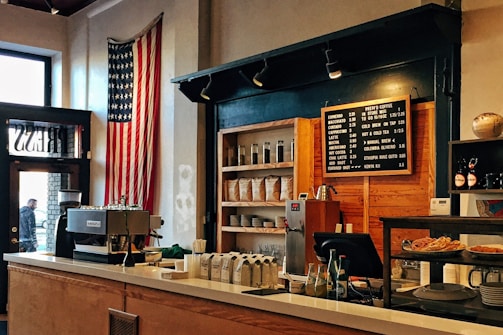 flag of U.S. America hanging on white painted concrete wall