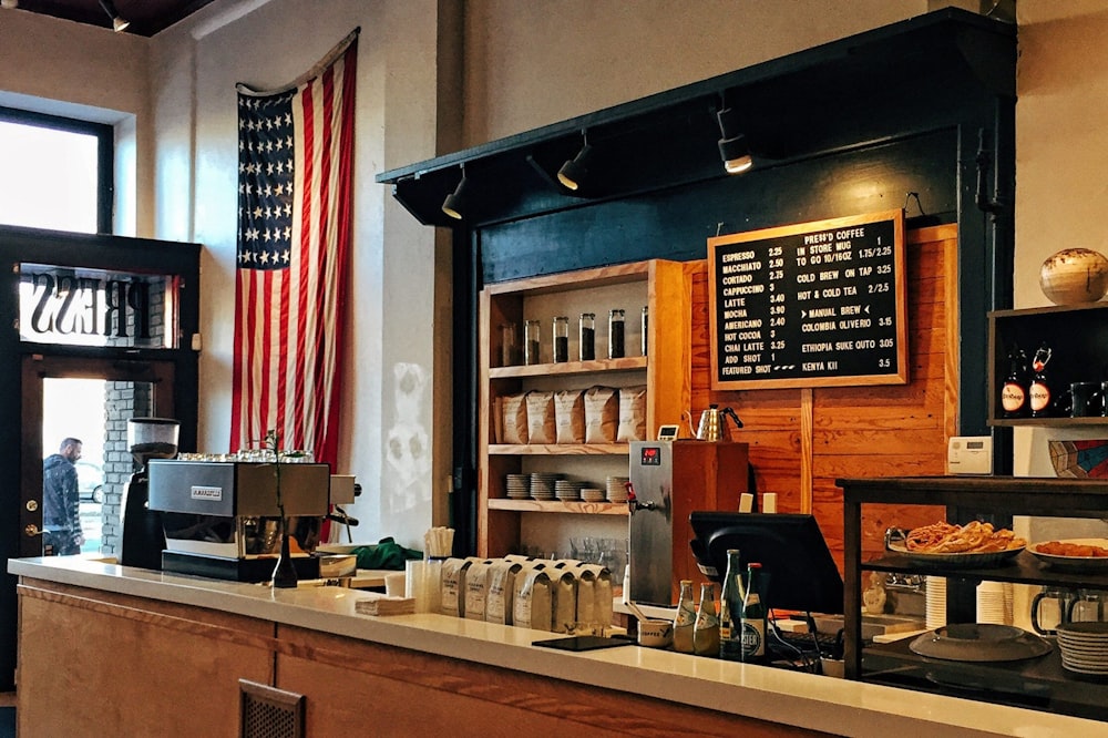 flag of U.S. America hanging on white painted concrete wall