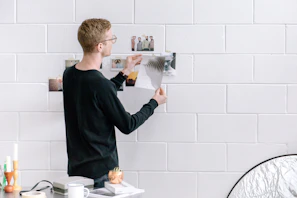 A team member helping a client hang a picture frame on the wall