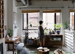 woman standing near brown wooden cabinet